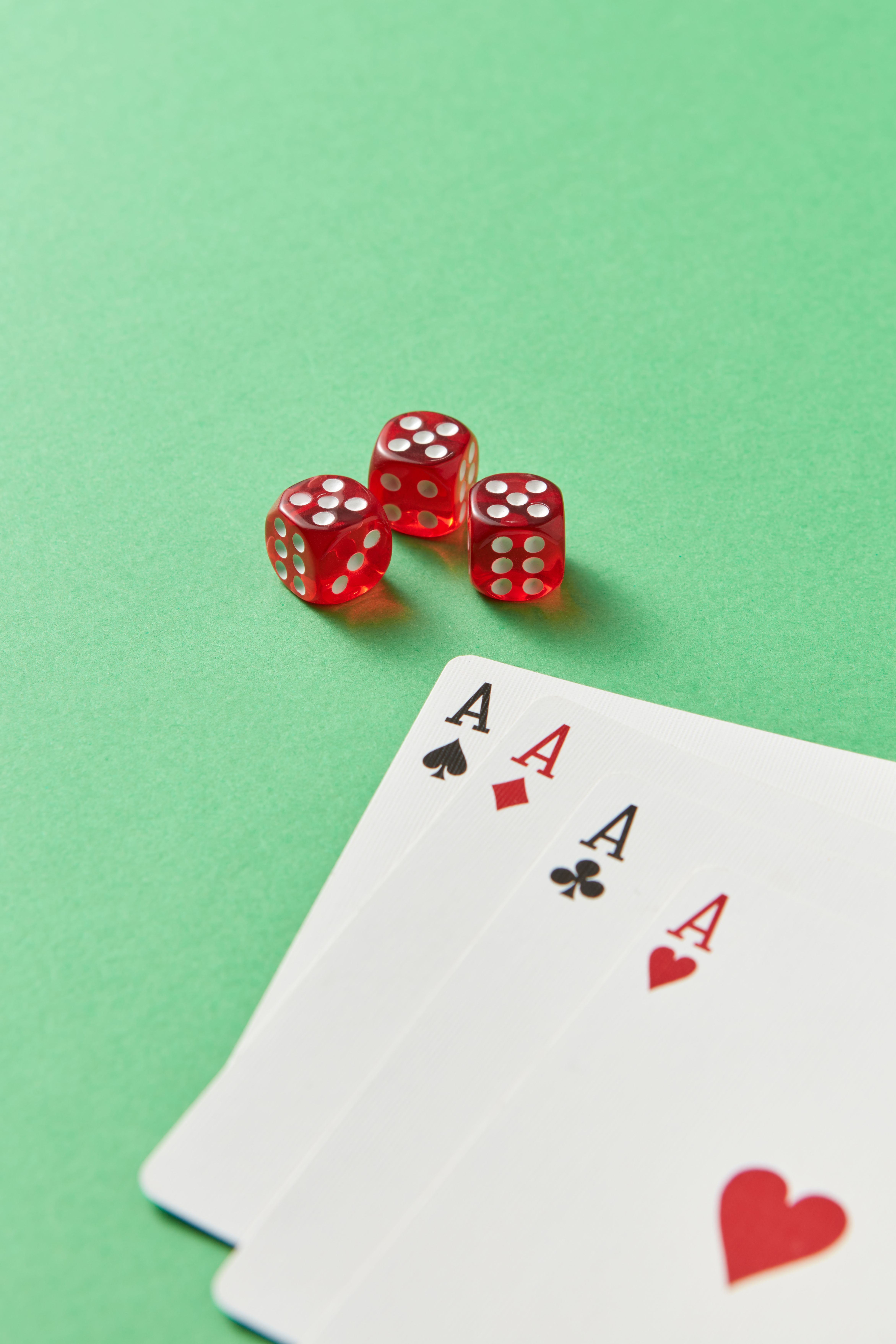Playing cards and dice representing real money card and rummy games