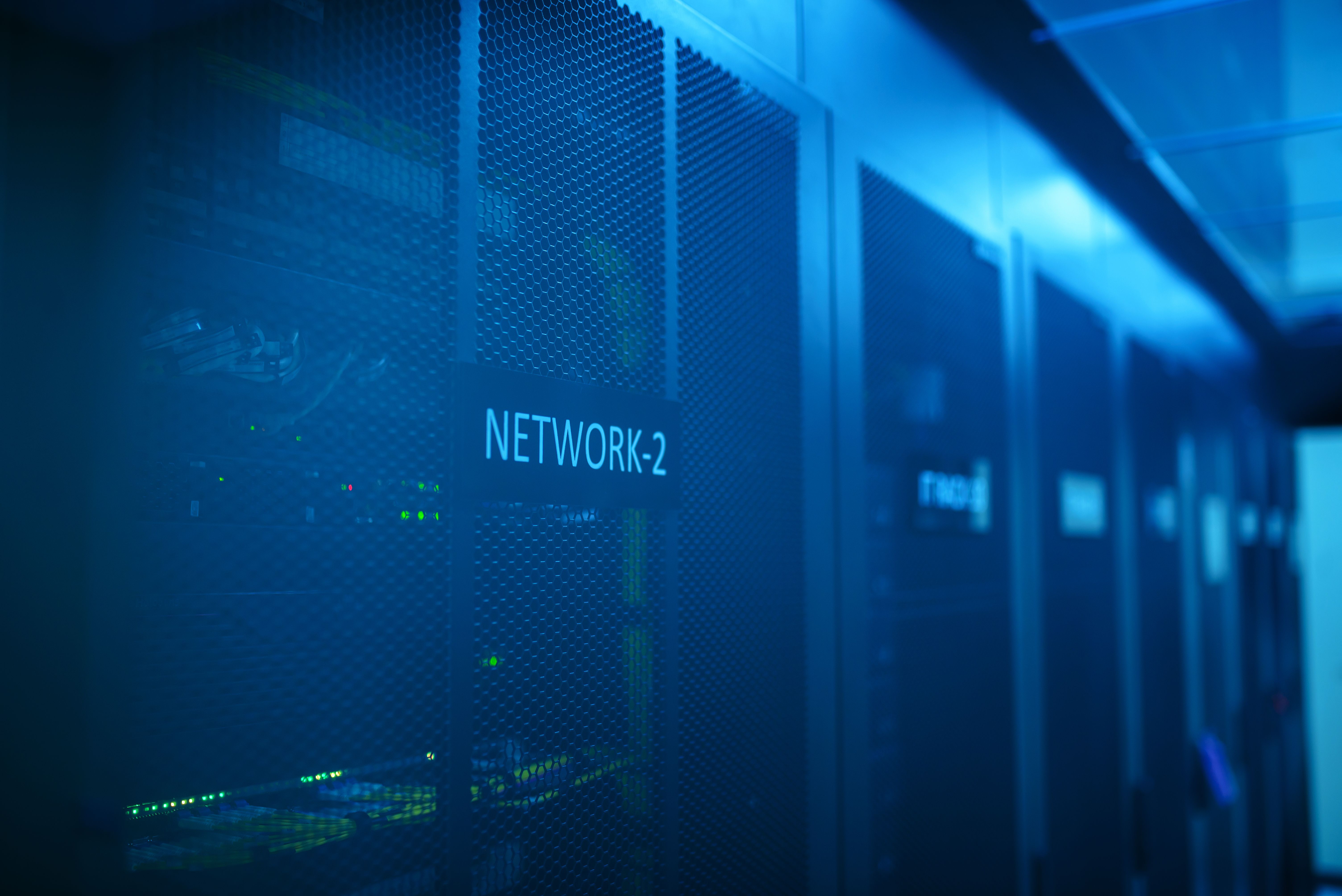 Modern server room with network equipment and blue illumination representing a private VPS hosting environment