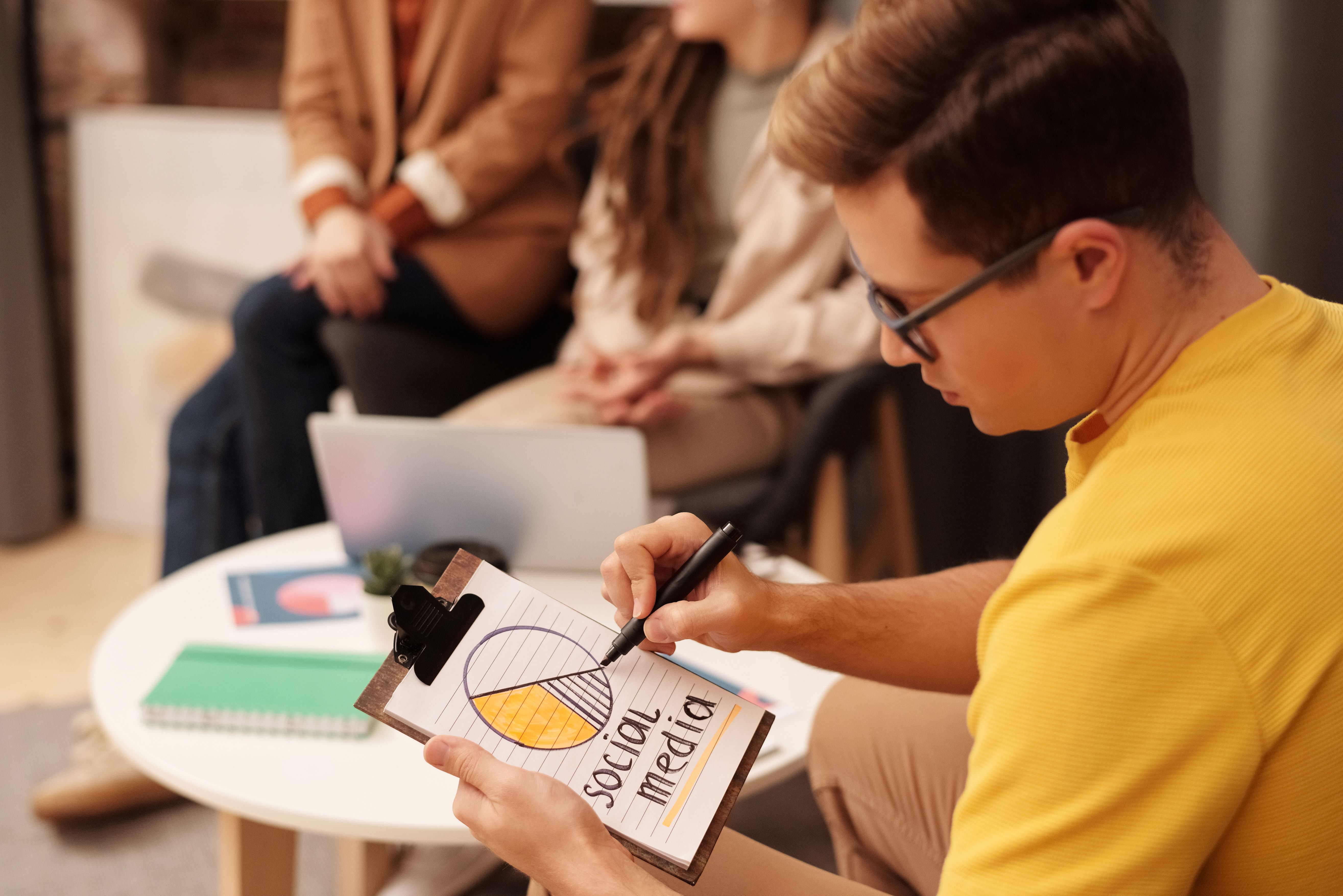 Marketing professionals reviewing social media strategy together in a modern office