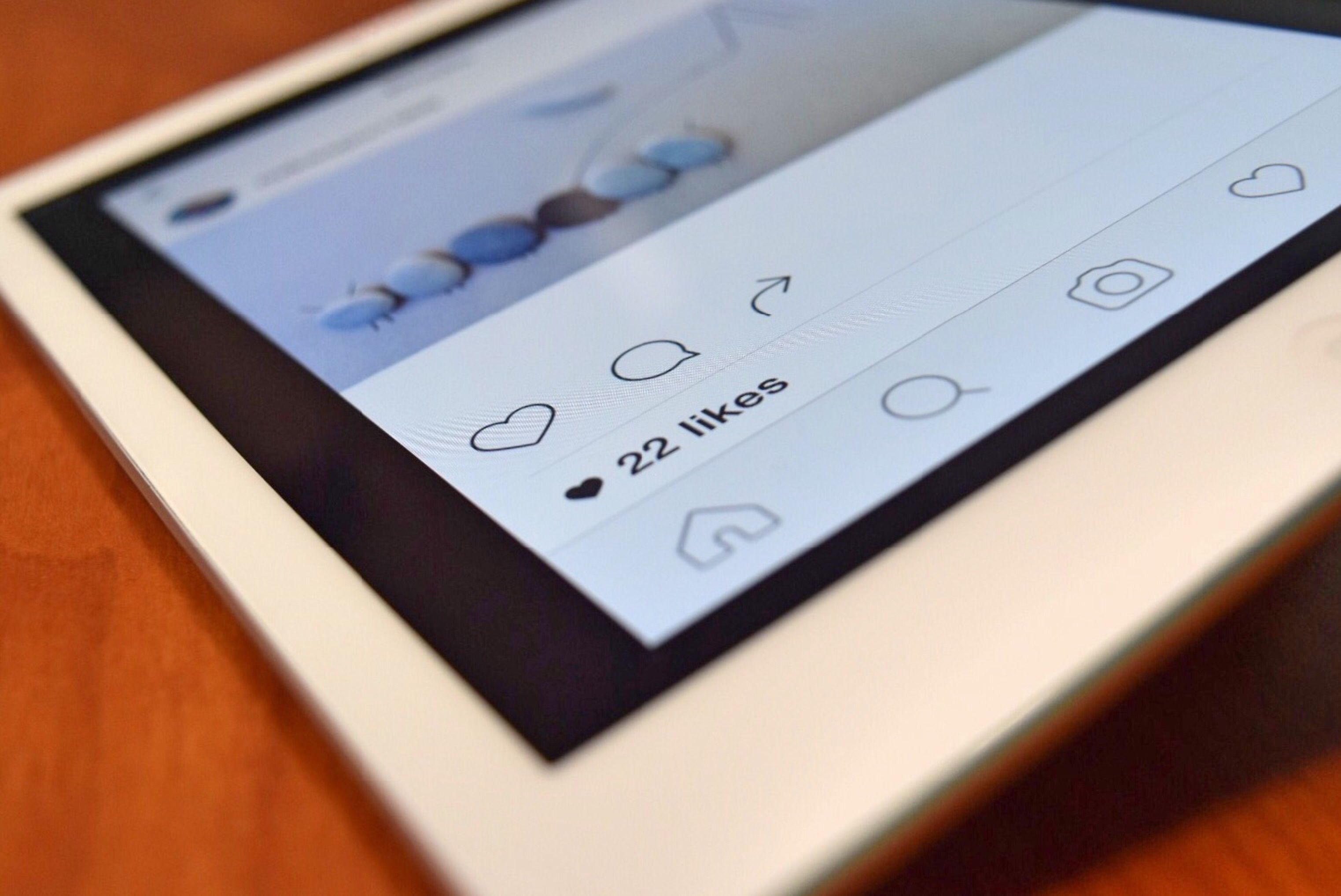 Tablet displaying a social media interface with a visible like count, illustrating engagement on a post.